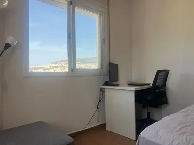 a bedroom with a desk with a computer and a window at Tétouan Rooftop Stay in Oulad Akkou