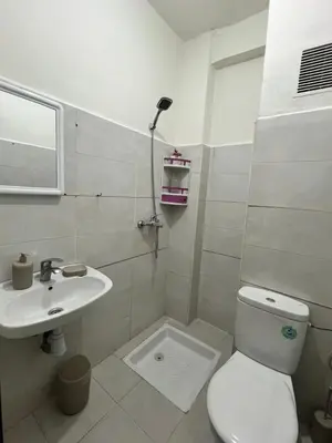 a bathroom with a toilet and a sink at Diyar tanger in Oulad Akkou
