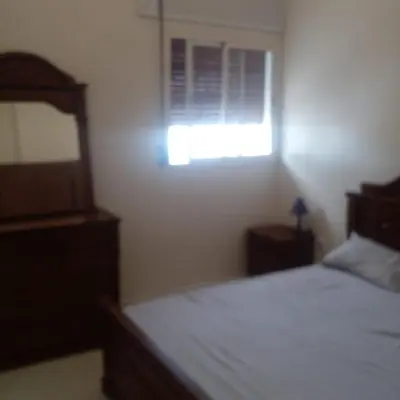 a bedroom with a bed and a window at ديار البوغاز in Oulad Akkou