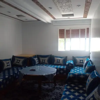 a living room with a couch and a table at ديار البوغاز in Oulad Akkou