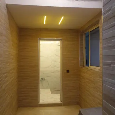 a bathroom with a shower with a glass door at ديار البوغاز in Oulad Akkou