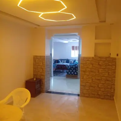 a living room with a dining table and a ceiling at ديار البوغاز in Oulad Akkou