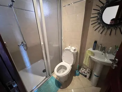 a bathroom with a toilet and a shower and a sink at Oum kaltoum in Oulad Akkou
