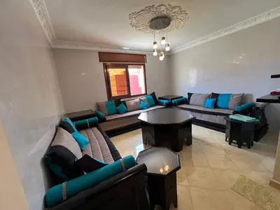 a large living room with couches and a table at Oum kaltoum in Oulad Akkou