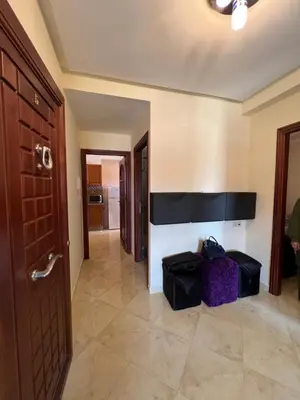 a hallway with a room with a door and some bags at Oum kaltoum in Oulad Akkou