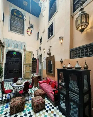 a living room with a red couch and chairs at Le panoramique de Fes in Fès