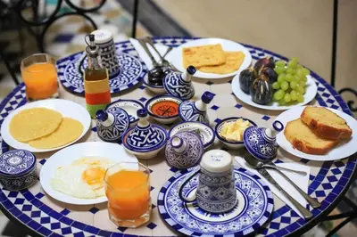 a table with blue and white plates of breakfast food at Le panoramique de Fes in Fès