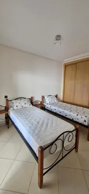 a bedroom with two beds in a room at Apartamentos rent me in Oulad Akkou