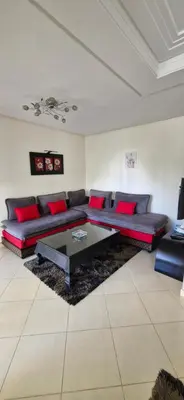 a living room with a couch and a table at Apartamentos rent me in Oulad Akkou