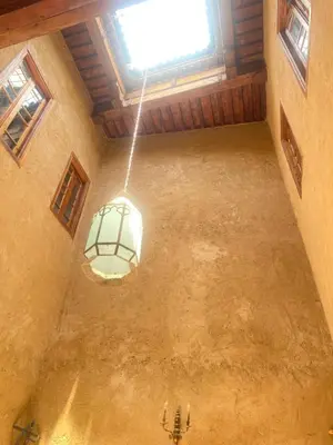 an empty room with a light hanging from a ceiling at Dar cheikh in Fès