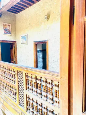 a balcony of a house with a wooden railing at Dar cheikh in Fès