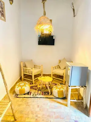 a living room with a tv and a table at Dar cheikh in Fès