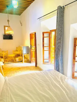 a bedroom with a bed and a living room at Dar cheikh in Fès
