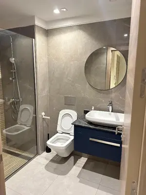 a bathroom with a toilet and a sink and a shower at Studio haut standing in Oulad Akkou