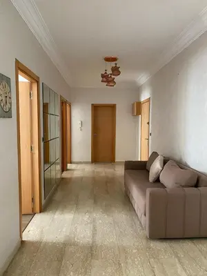 a living room with a couch in the middle at Marina Retreat in Oulad Akkou