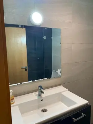 a bathroom with a sink and a large mirror at Marina Retreat in Oulad Akkou