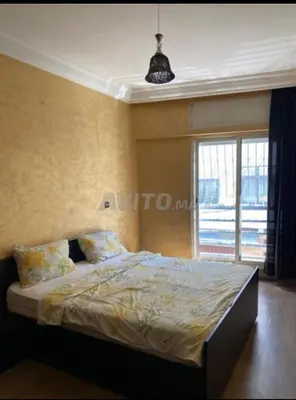 a bedroom with a bed and a large window at Marina Retreat in Oulad Akkou