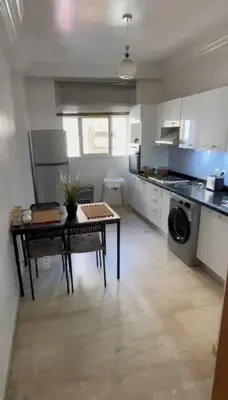 a kitchen with a table in the middle of a room at Marina Retreat in Oulad Akkou