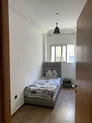 a bedroom with a bed in the corner of a room at Marina Retreat in Oulad Akkou
