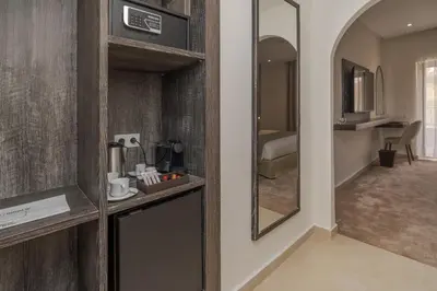 a hotel room with a kitchen and a bedroom at Amanar Hôtel & Spa Ouarzazate in Ouarzazate