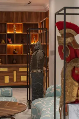 a living room with a bed and a shelf at Amanar Hôtel & Spa Ouarzazate in Ouarzazate