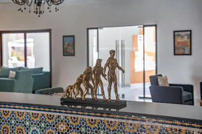a statue of three children on a counter in a living room at Amanar Hôtel & Spa Ouarzazate in Ouarzazate