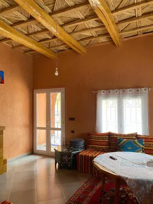 a living room with a couch and a table at Kasbah in El Hart