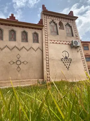 a building with signs on the side of it at Kasbah in El Hart