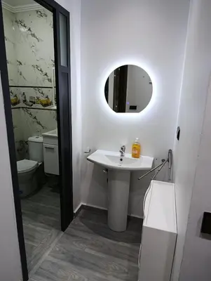 a bathroom with a sink and a mirror at La maison bleu in Oulad Akkou