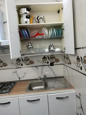 a kitchen with a sink and a counter top at La maison bleu in Oulad Akkou