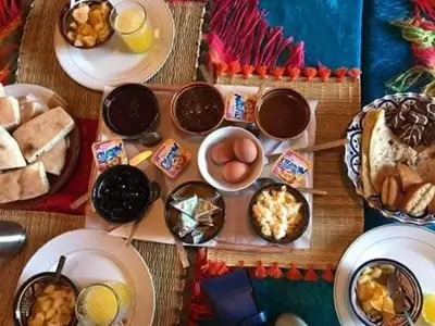 a table of food with eggs and other foods at visitando el desierto in Merzouga