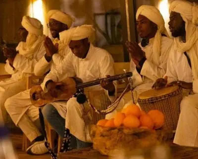 a group of men in white turbans with a gun at Luxurious magic camp in Merzouga