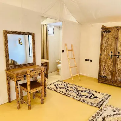a room with a mirror and a dressing table and a ladder at Luxurious magic camp in Merzouga