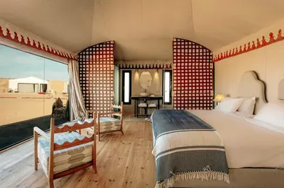 a bedroom with two beds and a large window at Excursions morocco in Oulad Akkou