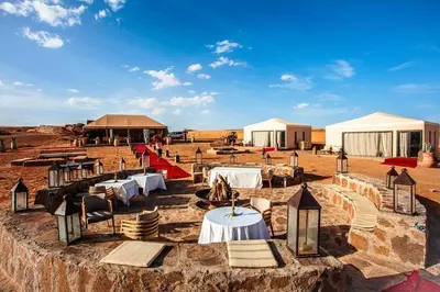 a group of tables and tents in the desert at Excursions morocco in Oulad Akkou