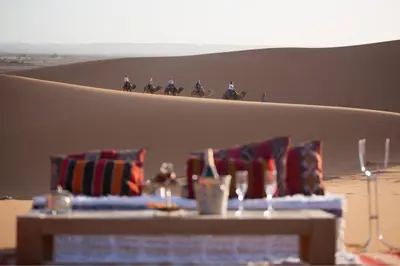 a group of people riding horses in the desert at Excursions morocco in Oulad Akkou