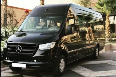 a black van parked in a parking lot at Excursions morocco in Oulad Akkou