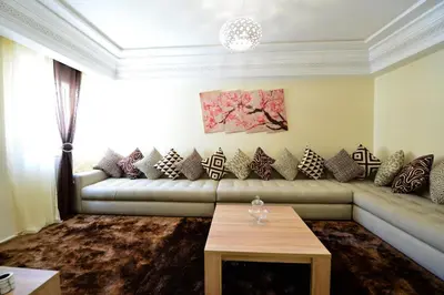 a living room with a couch and a table at Tifawt in Oulad Akkou