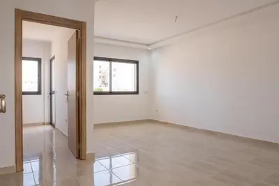 an empty room with white walls and a window at Tifawt in Oulad Akkou