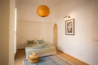 a bedroom with a bed and a basket on the floor at Luxueuse villa VALERIA avec gouvernante in Chaibate