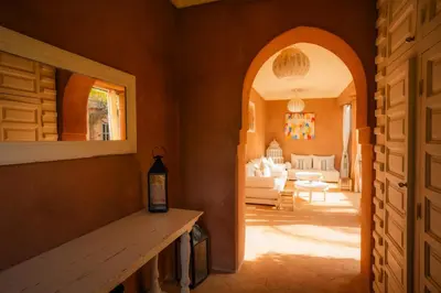 a room with an archway and a living room at Luxueuse villa VALERIA avec gouvernante in Chaibate