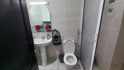 a bathroom with a sink and a toilet and a mirror at Appartement in Oulad Akkou