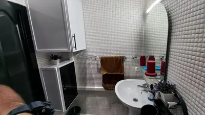 a small bathroom with a sink and a mirror at Appartement in Oulad Akkou