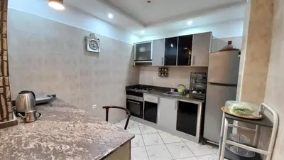 a kitchen with stainless steel appliances and a counter top at Appartement in Oulad Akkou