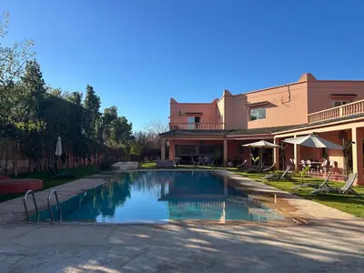 a swimming pool in front of a building at Villa Essalah & Spa Marrakech in Marrakech