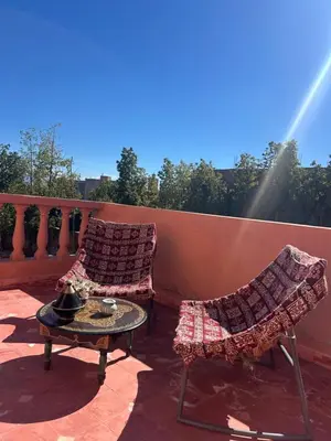 two chairs and a table on a balcony at Villa Essalah & Spa Marrakech in Marrakech