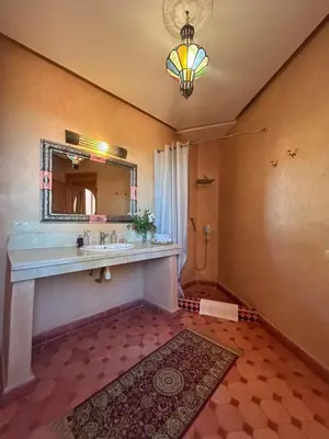 a bathroom with a sink and a mirror at Villa Essalah & Spa Marrakech in Marrakech