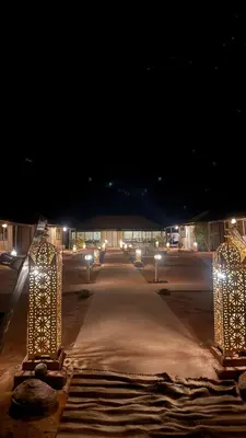 a group of lights on a street at night at Tasnim Désert Camp & Activités in Merzouga