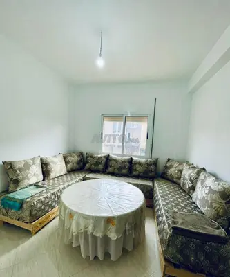 a living room with a couch and a table at Lot HABIBA in Khemisset