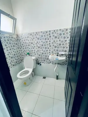 a bathroom with a toilet and a sink at Lot HABIBA in Khemisset